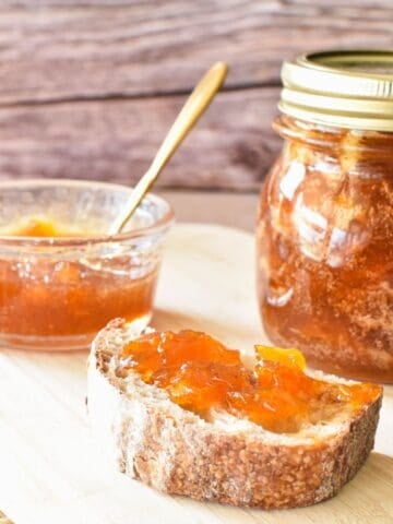 Pumpkin Jam on toast with jar in background.