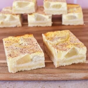 Apple and Sour cream Slice on wooden serving board.